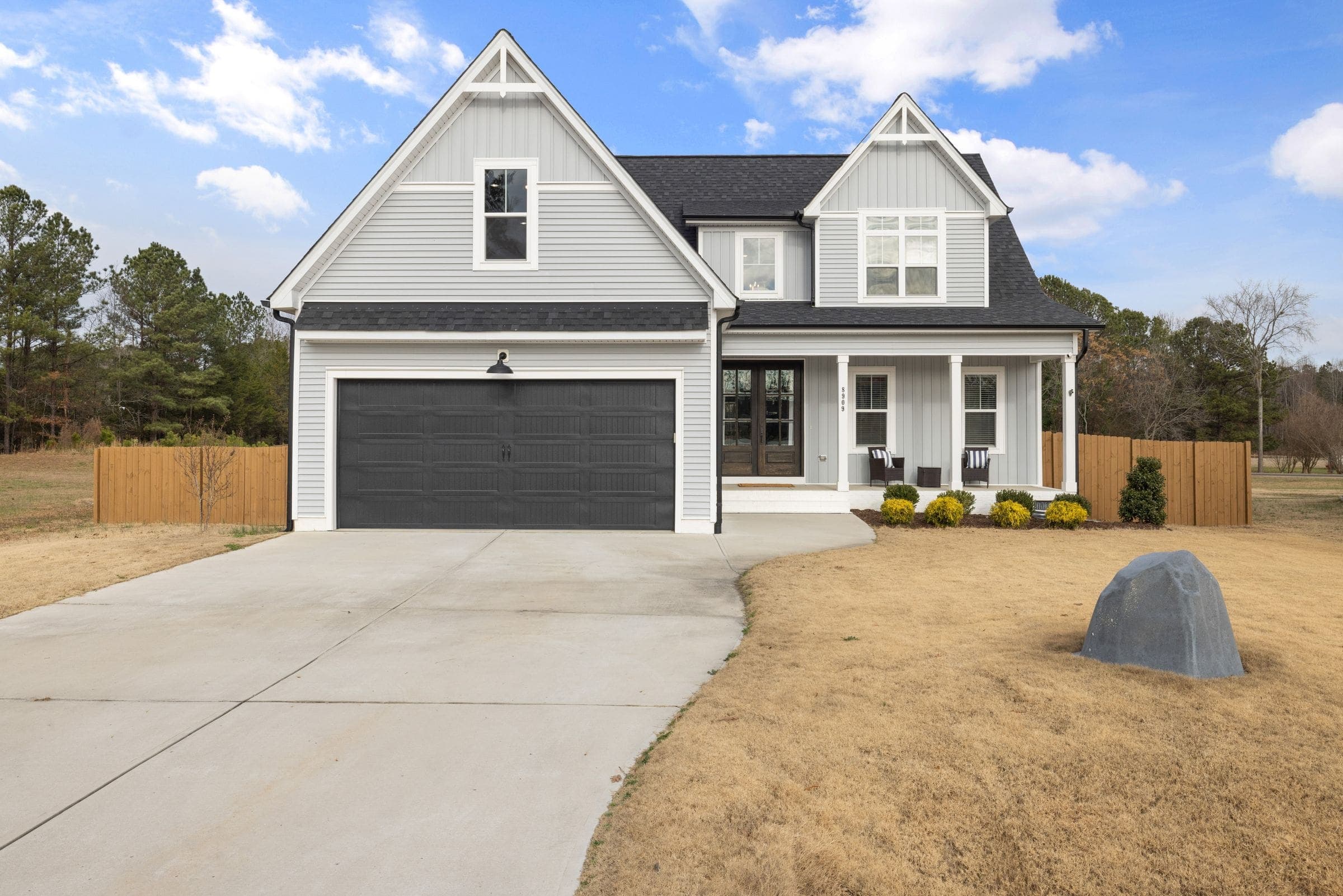 Newer two-story home with a concrete driveway on a large lot like homes in Eastover NC